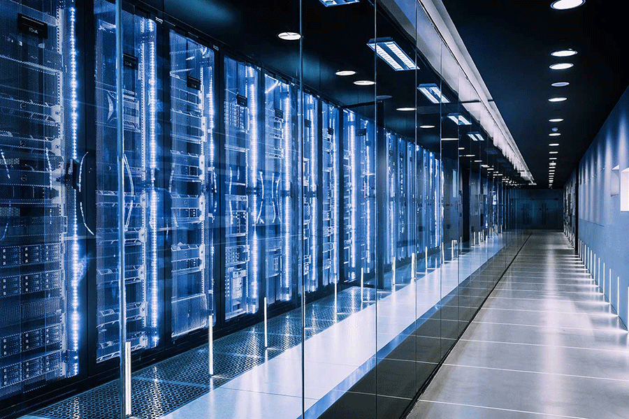 A hallway of technology equipment with blue lighting