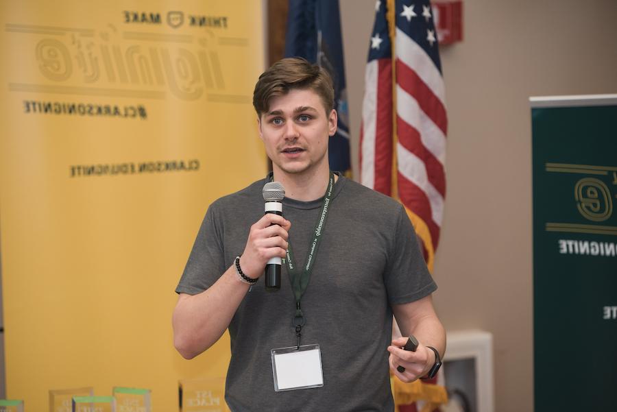 Young man speaks into a handheld microphone 